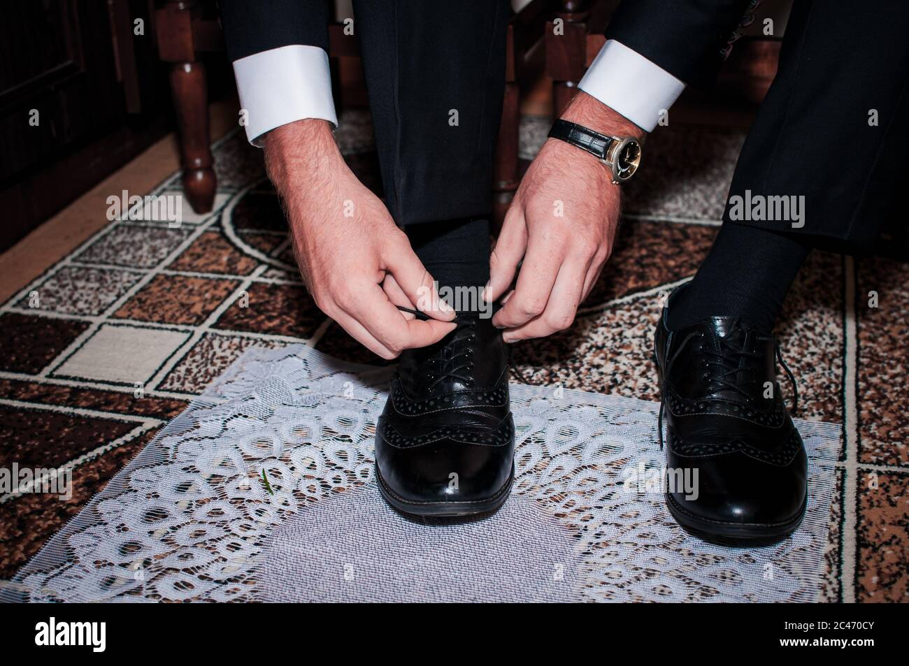 White man puts black shoes on the white background Stock Photo Alamy