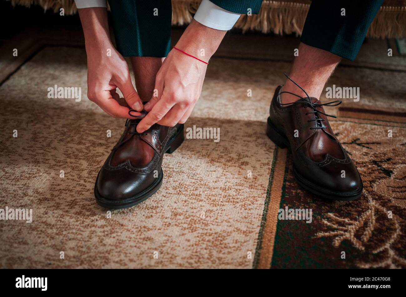 White man puts black shoes on the legs Stock Photo Alamy