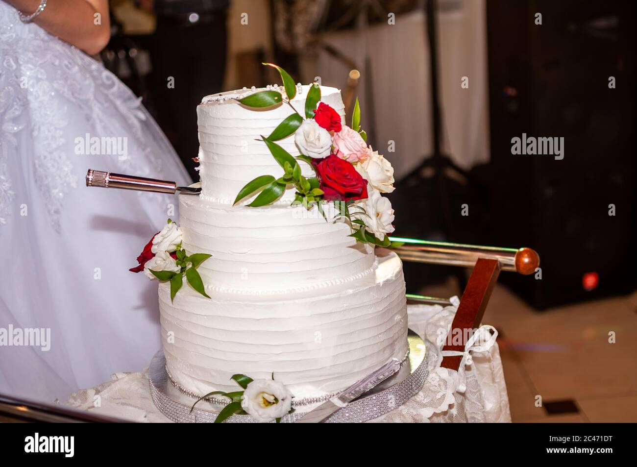 Bride and groom cuting white wedding cake Stock Photo