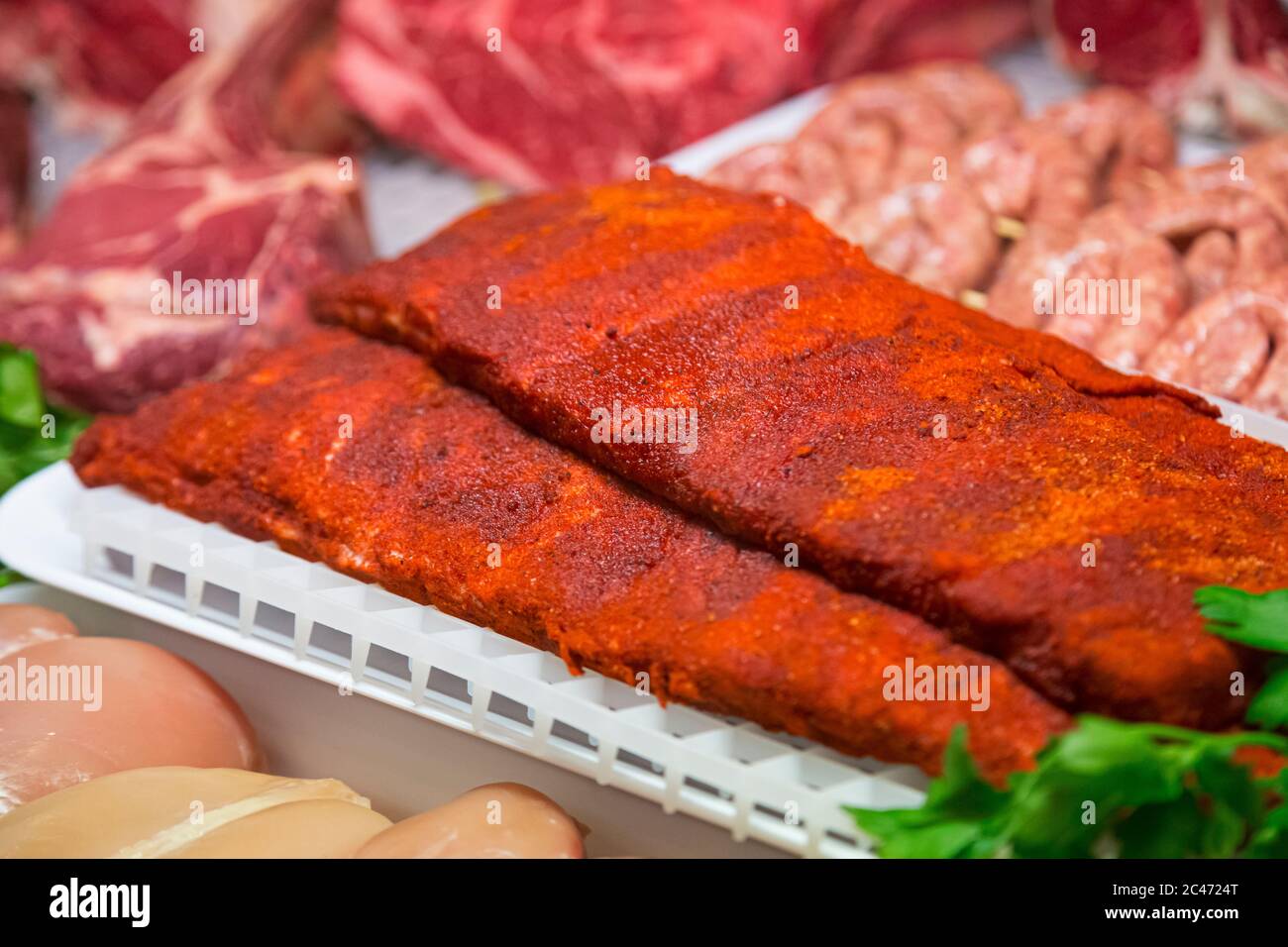 Raw meat in butcher's shop Stock Photo