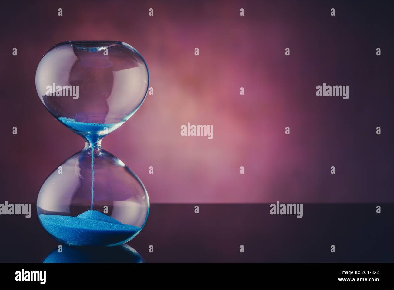 Flowing blue sand hourglass Stock Photo Alamy