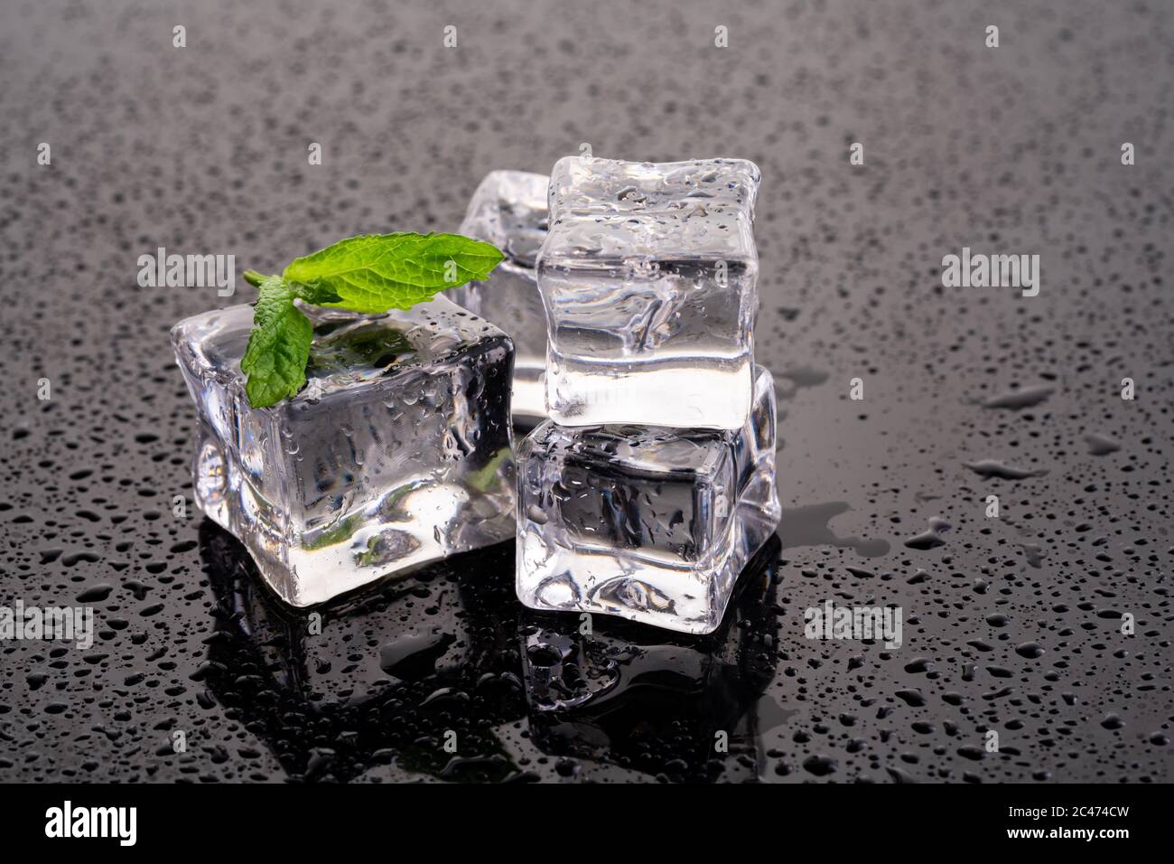 Ice cubes and mint on wet background Stock Photo