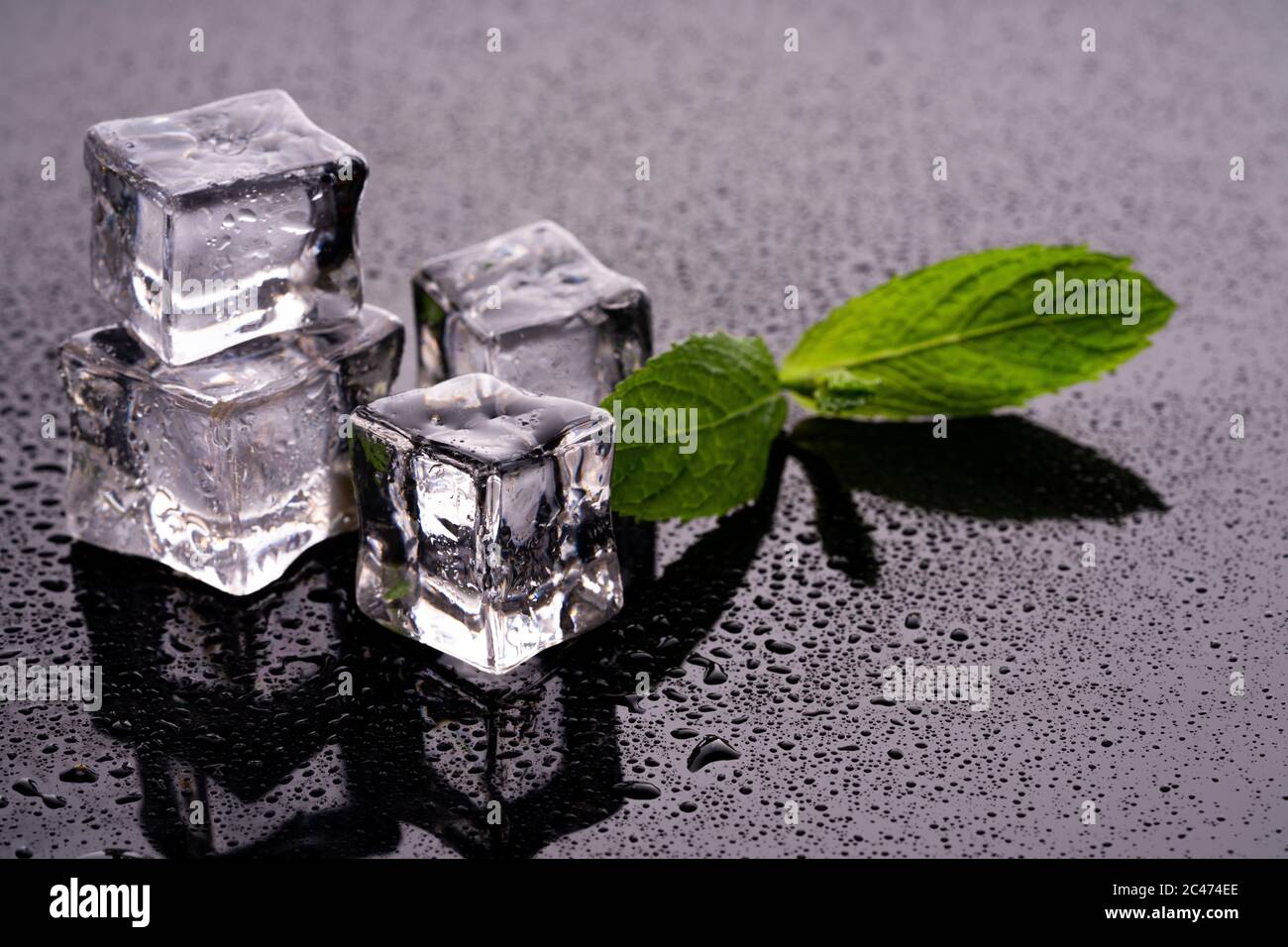 Ice cubes and mint on wet background Stock Photo