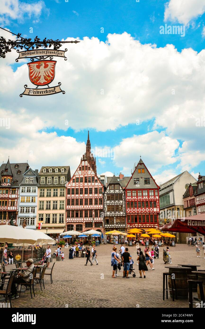 Picturesque view of the eastern section ("Ostzeile") of central Römerberg Square with a sign for sales of Frankfurt's city wine; Frankfurt, Germany. Stock Photo