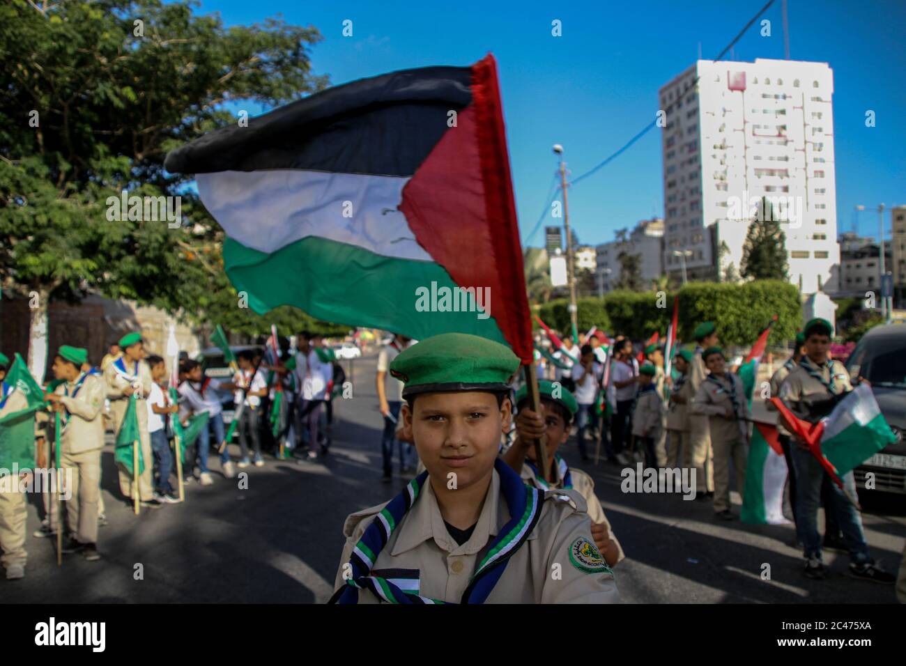 January 1, 2000: Gaza, Palestine. 24 June 2020. Different groups of the local scout association attend a rally in Gaza City to reject the Israeli government's plan to annex parts of the West Bank. Israeli prime Minister Netanyahu, backed by US president Trump, is planning to confiscate territories in the West Bank containing Israeli settlements as well as the Jordan valley, incorporating up to 30% of the Palestinian territories into Israel. The plan on land annexation has been opposed by more than 1,000 parliamentarians from across Europe, who have signed a letter strongly condemning the mov Stock Photo