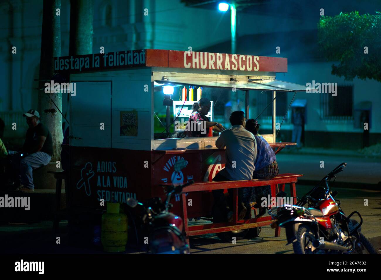Local indigenous Poqomchi Maya people eating in the evening at a food