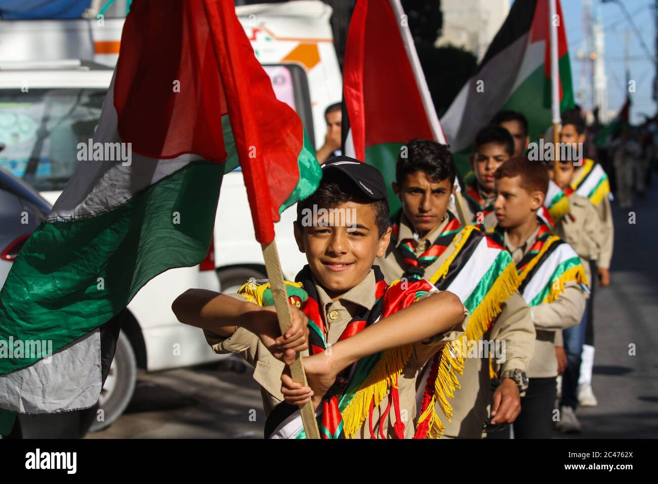 June 24, 2020: Gaza, Palestine. 24 June 2020. Different groups of the local scout association attend a rally in Gaza City to reject the Israeli government's plan to annex parts of the West Bank. Israeli prime Minister Netanyahu, backed by US president Trump, is planning to confiscate territories in the West Bank containing Israeli settlements as well as the Jordan valley, incorporating up to 30% of the Palestinian territories into Israel. The plan on land annexation has been opposed by more than 1,000 parliamentarians from across Europe, who have signed a letter strongly condemning the move Stock Photo
