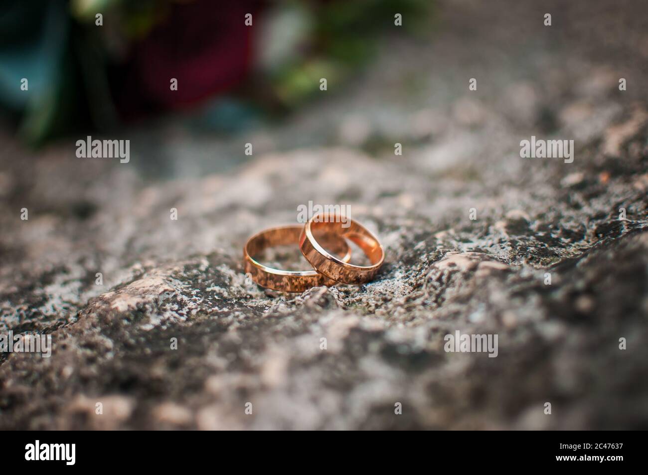 Pair of gold wedding rings on the stone Stock Photo