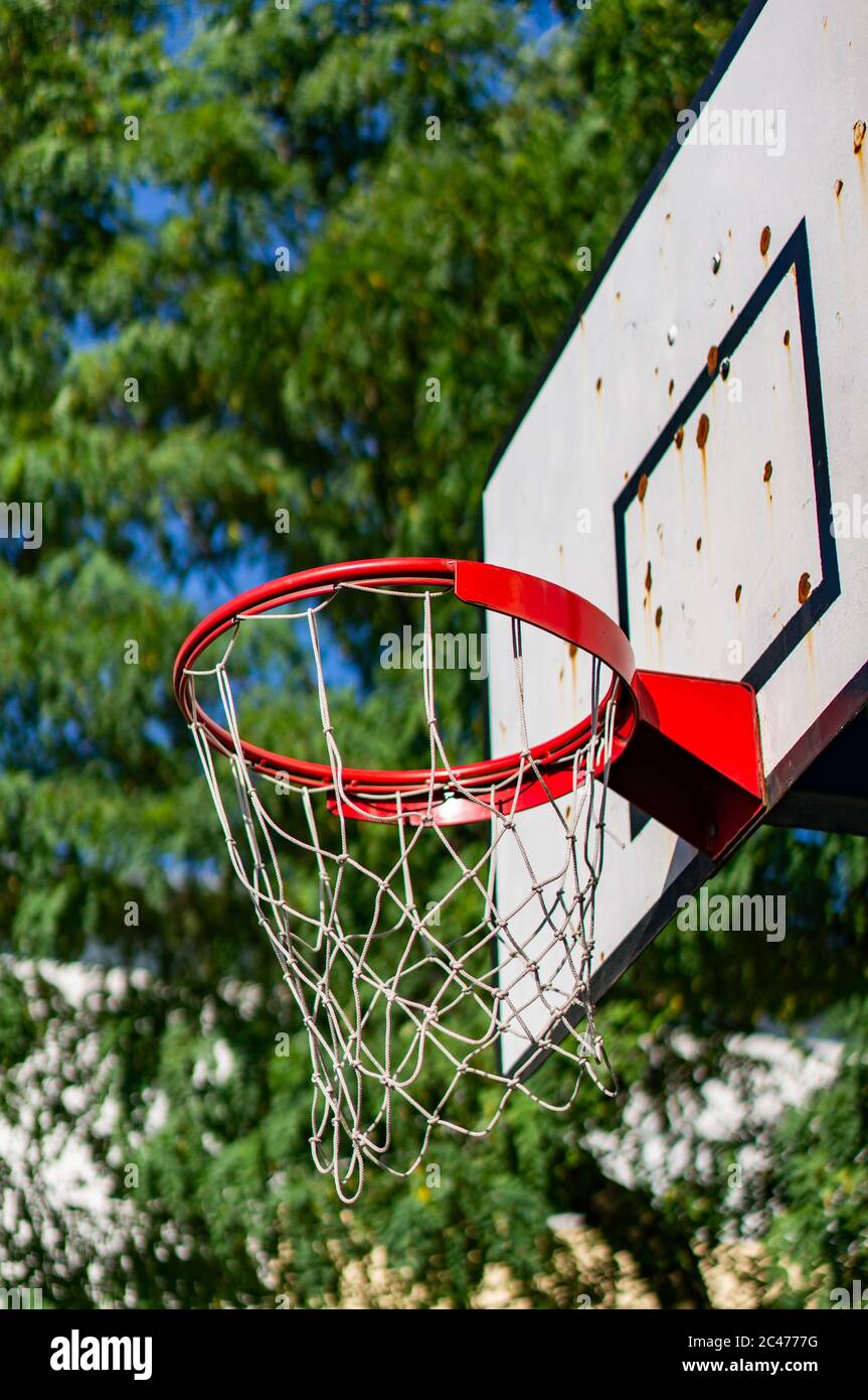 Vertical low angle shot of a basketball hoop with a blurred background Stock Photo