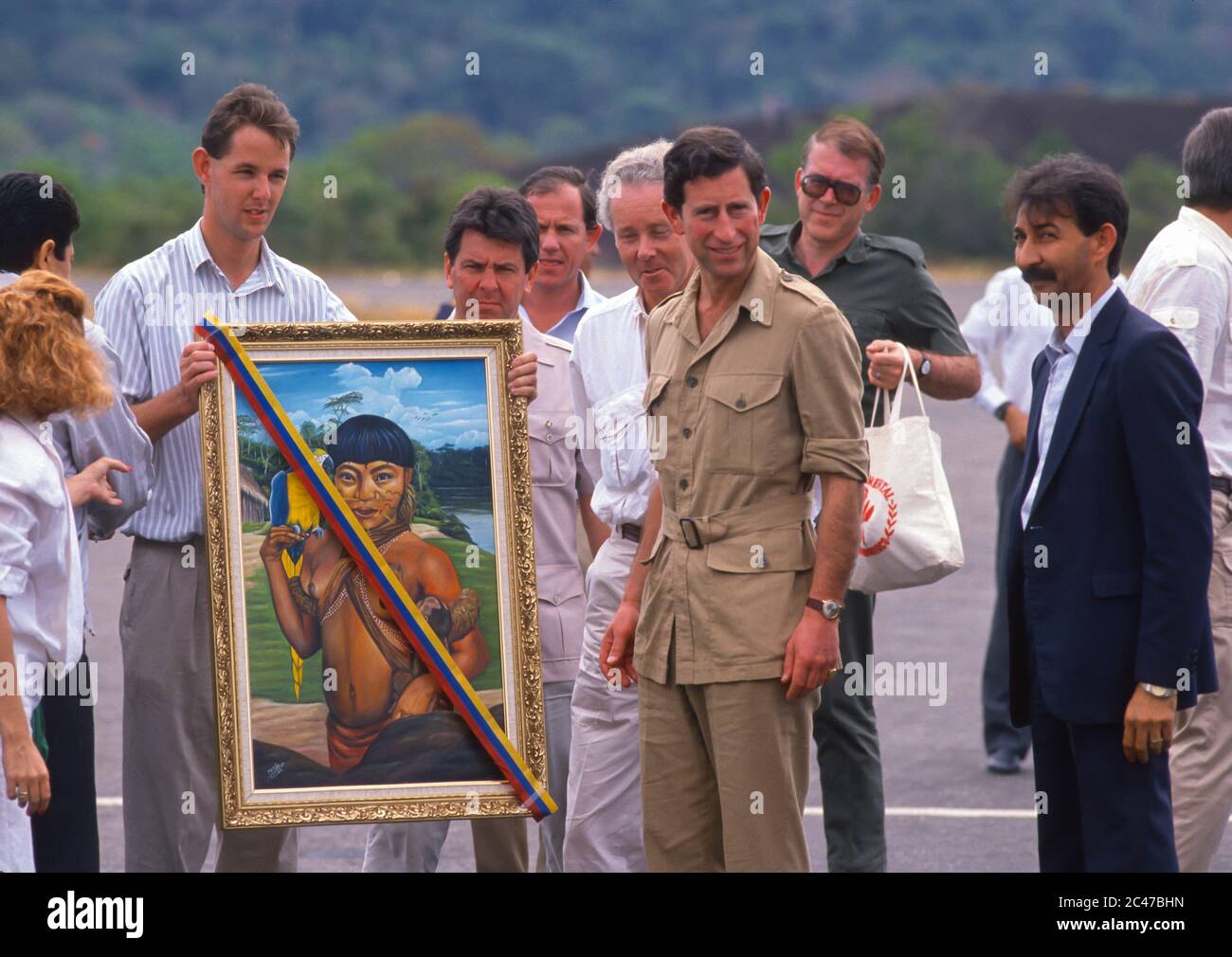 AMAZONAS TERRITORY, VENEZUELA, FEBRUARY 24, 1989 - Prince Charles receives gift painting at airport, during visit to jungle. Stock Photo