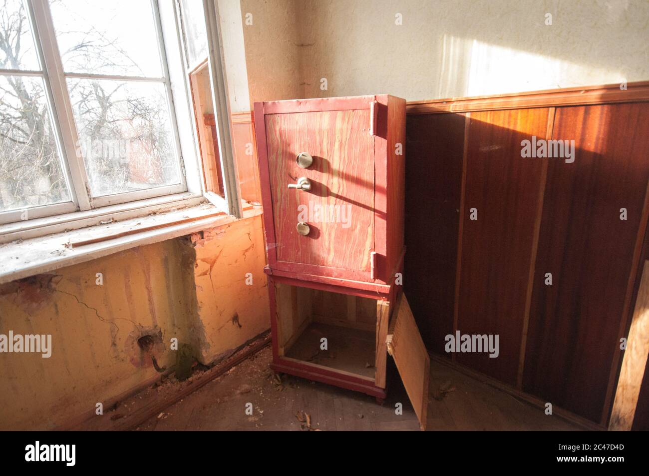 Red steel safe in the abandoned room Stock Photo