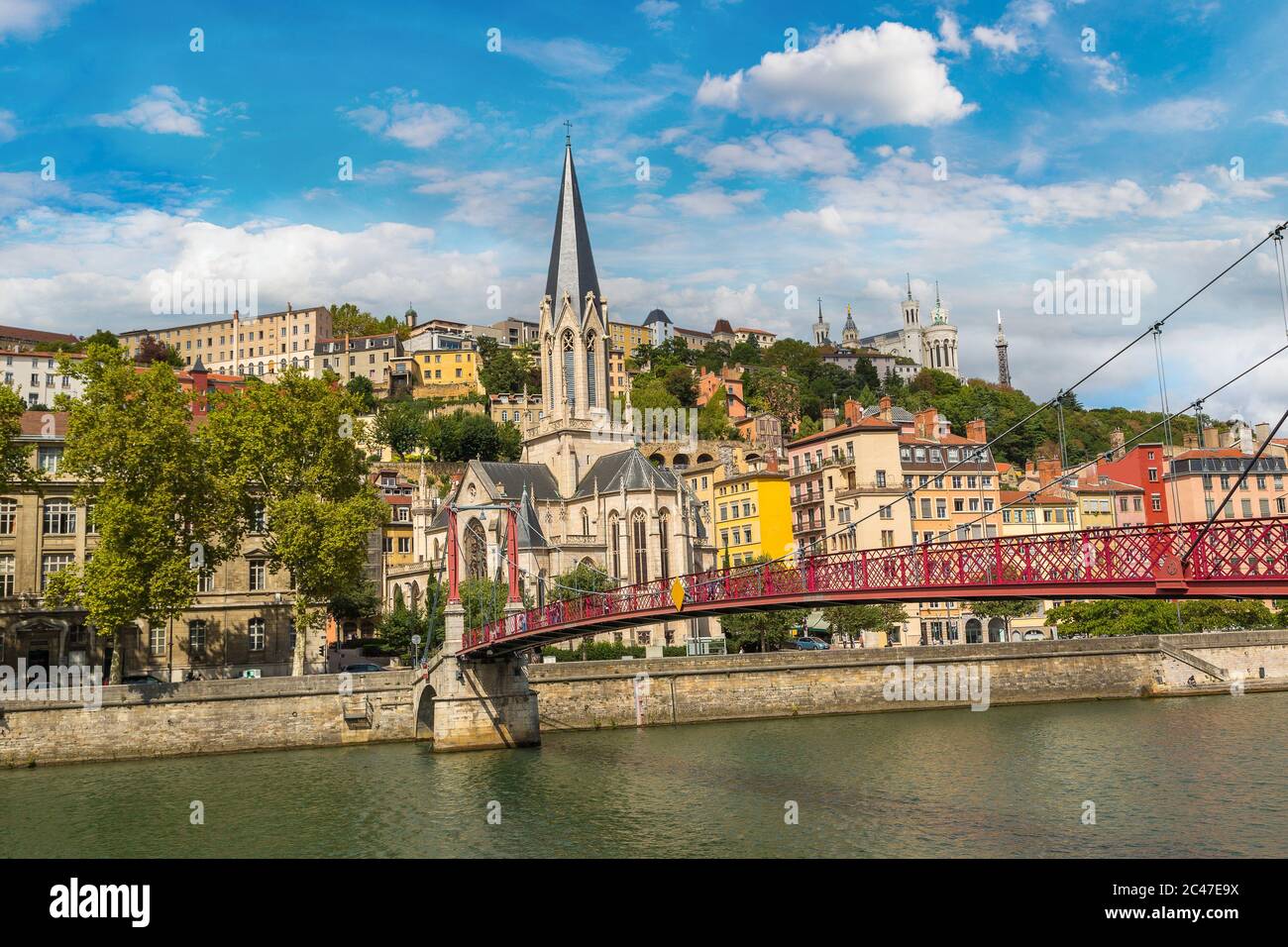 Pedestrian Saint Georges footbridge and the Saint Georges church in Lyon, France in a beautiful summer day Stock Photo