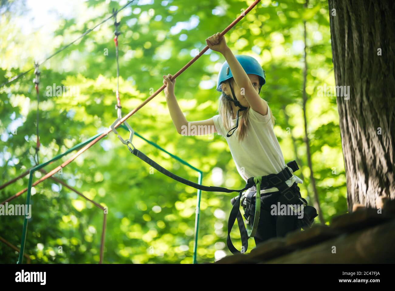 Step Onto Rope Bridge Rope adventure - a little girl walks on the rope bridge from the stand ...