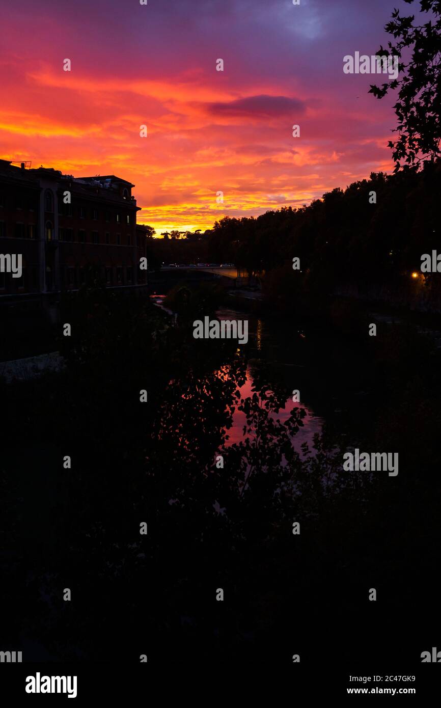 Silhouette of the city at sunset over the Tiber river in Rome, Italy Stock Photo