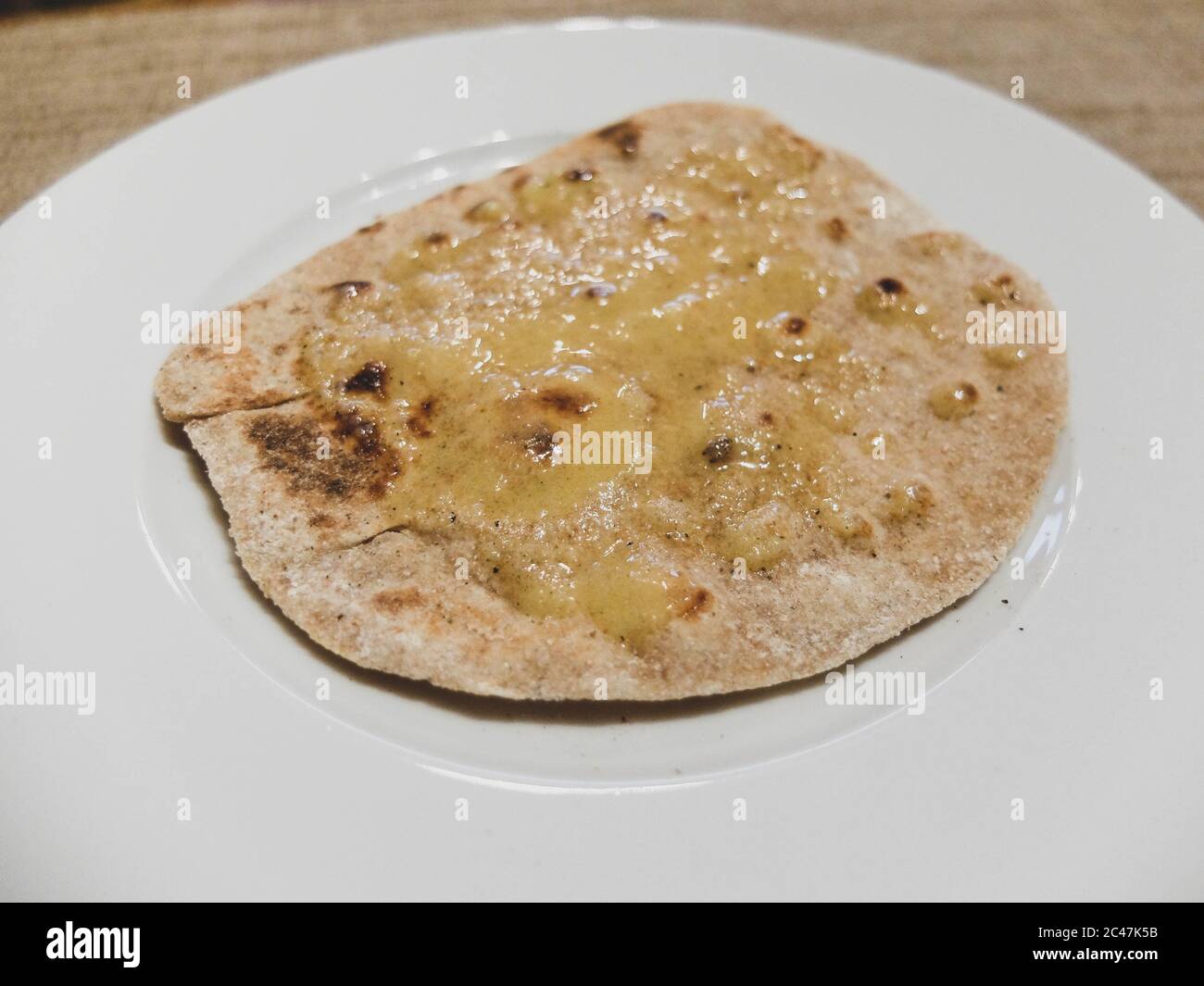 Indian homemade chapati with ghee. Chapati is a flat bread from India, made with only water