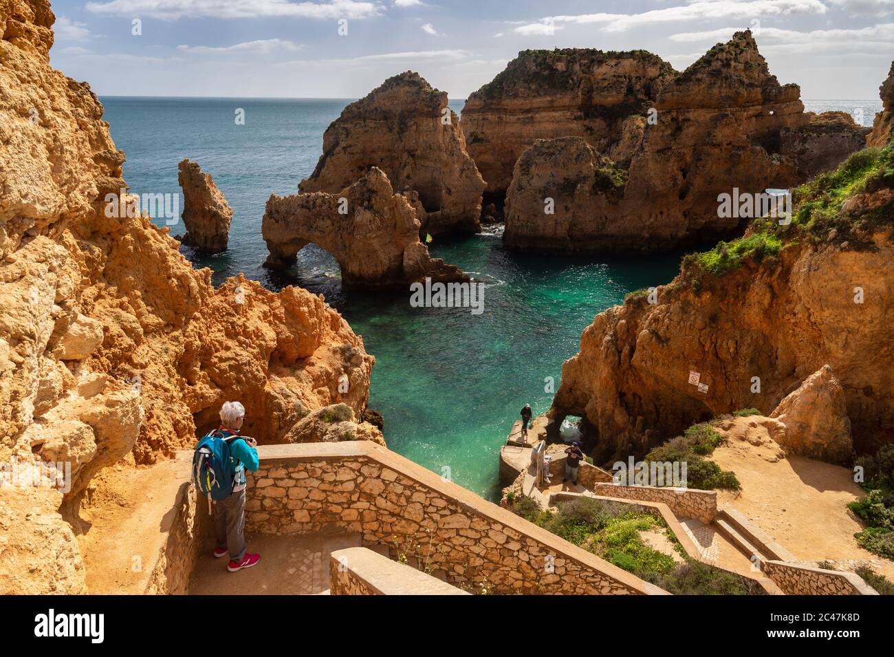 Lagos, Portugal - 6 March 2020: Tourist looking at the cliffs at Ponta da Piedade Stock Photo