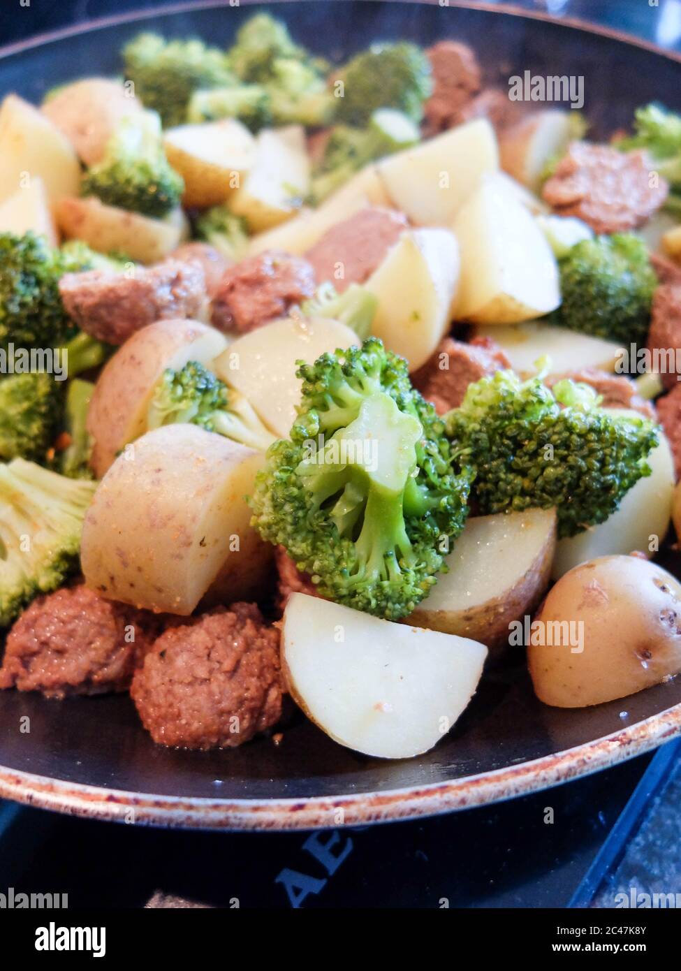 Yummy vegetarian dish in the pan : potatoes, veggie meatball and brocolis Stock Photo