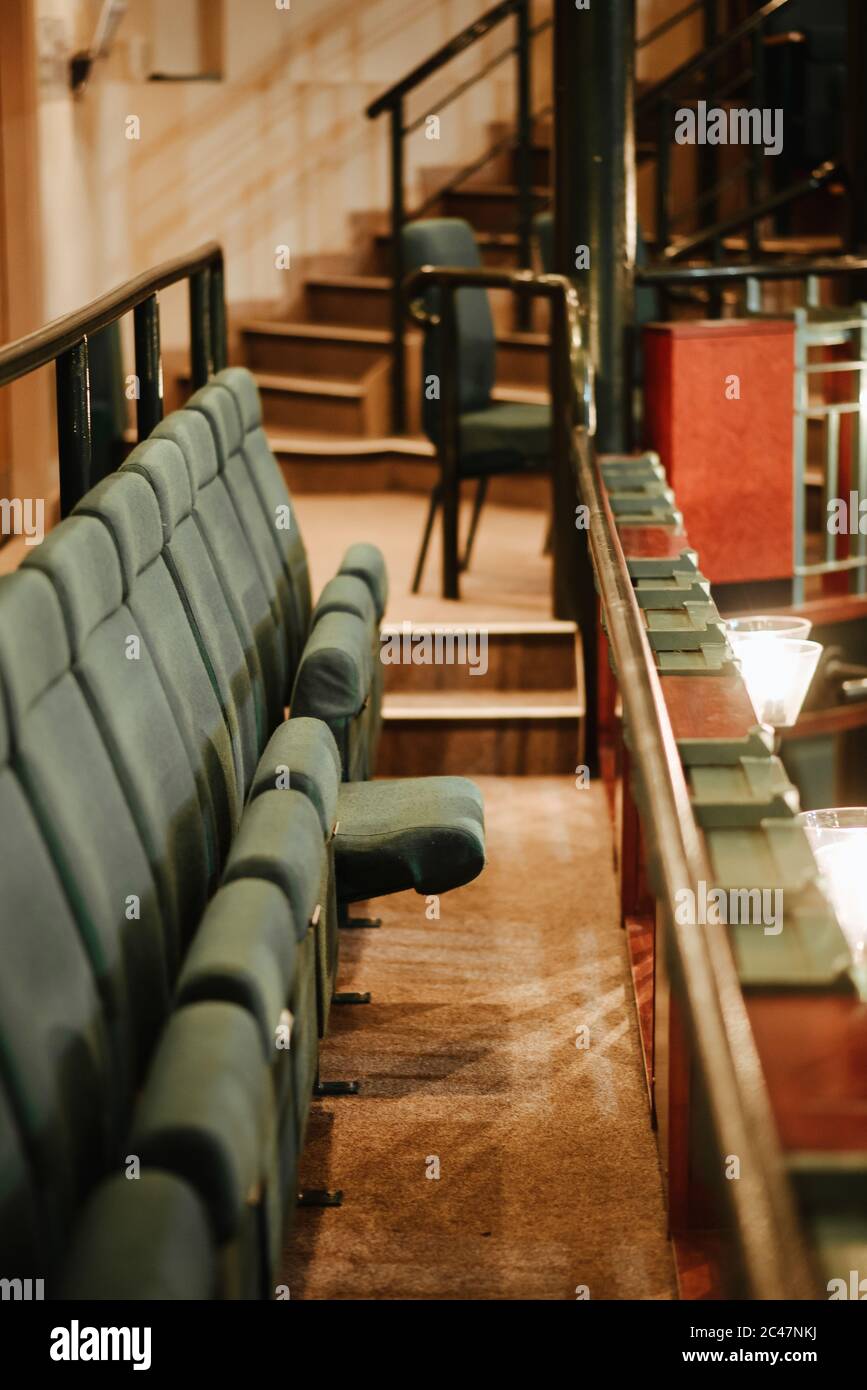 Shot of a sitting row with green chairs in a theatre Stock Photo