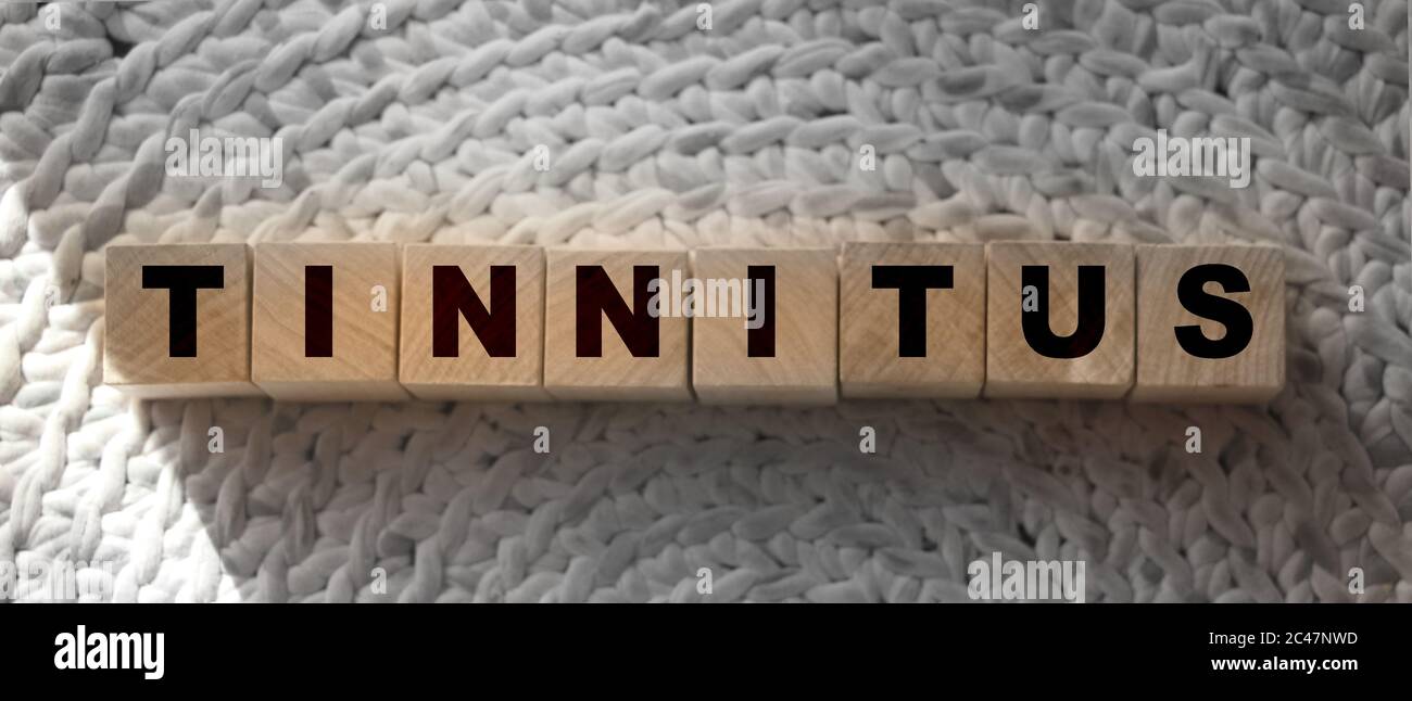 TINNITUS word written on wood block. TINNITUS text on wooden table for your desing,. Healthcare concept Stock Photo