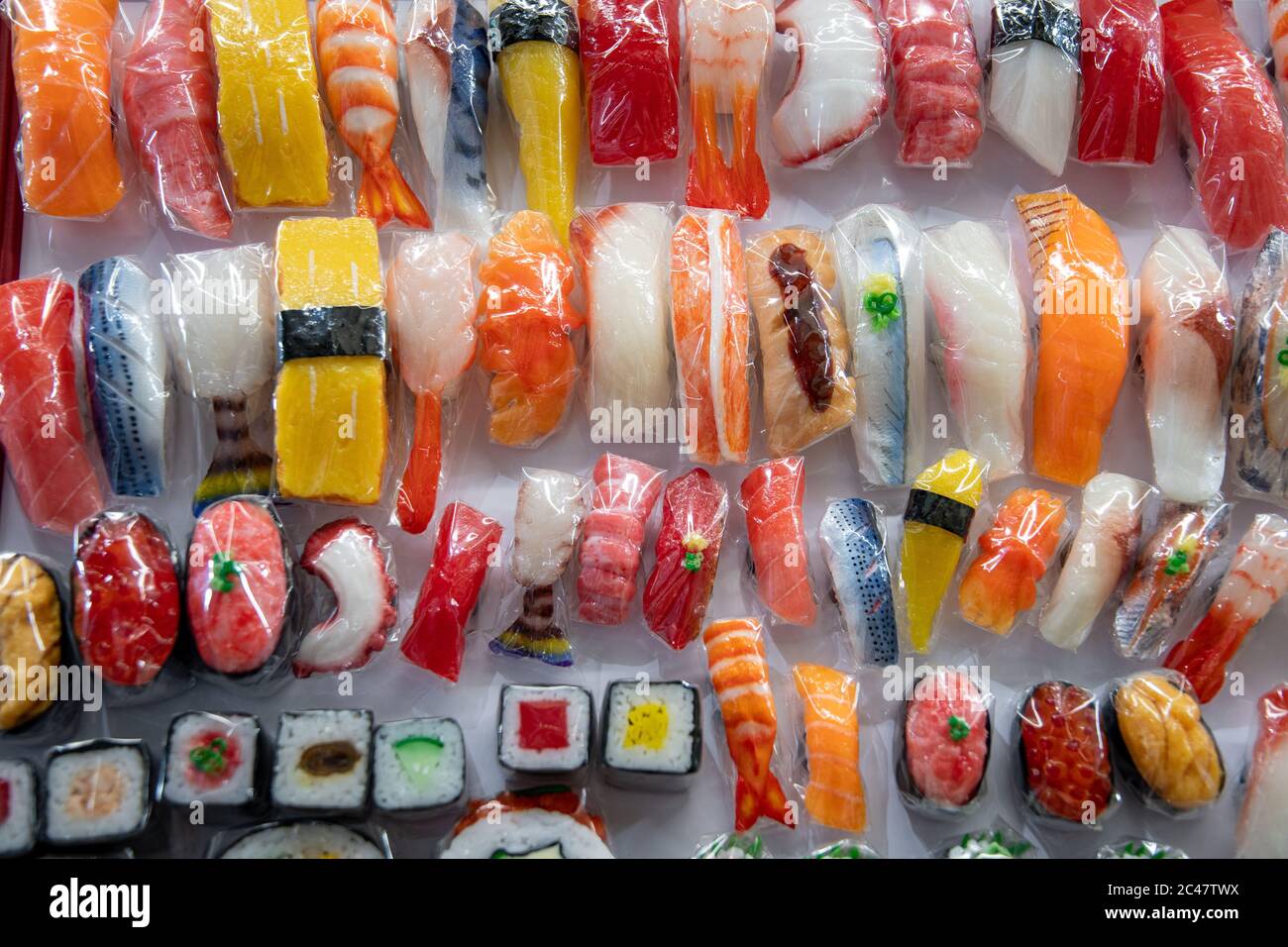 Close-up on sushi and onigiri magnet. Artificial food made by wax. Shop window display, souvenir, restaurant menu food sample. Kappabashi dori, Tokyo. Stock Photo