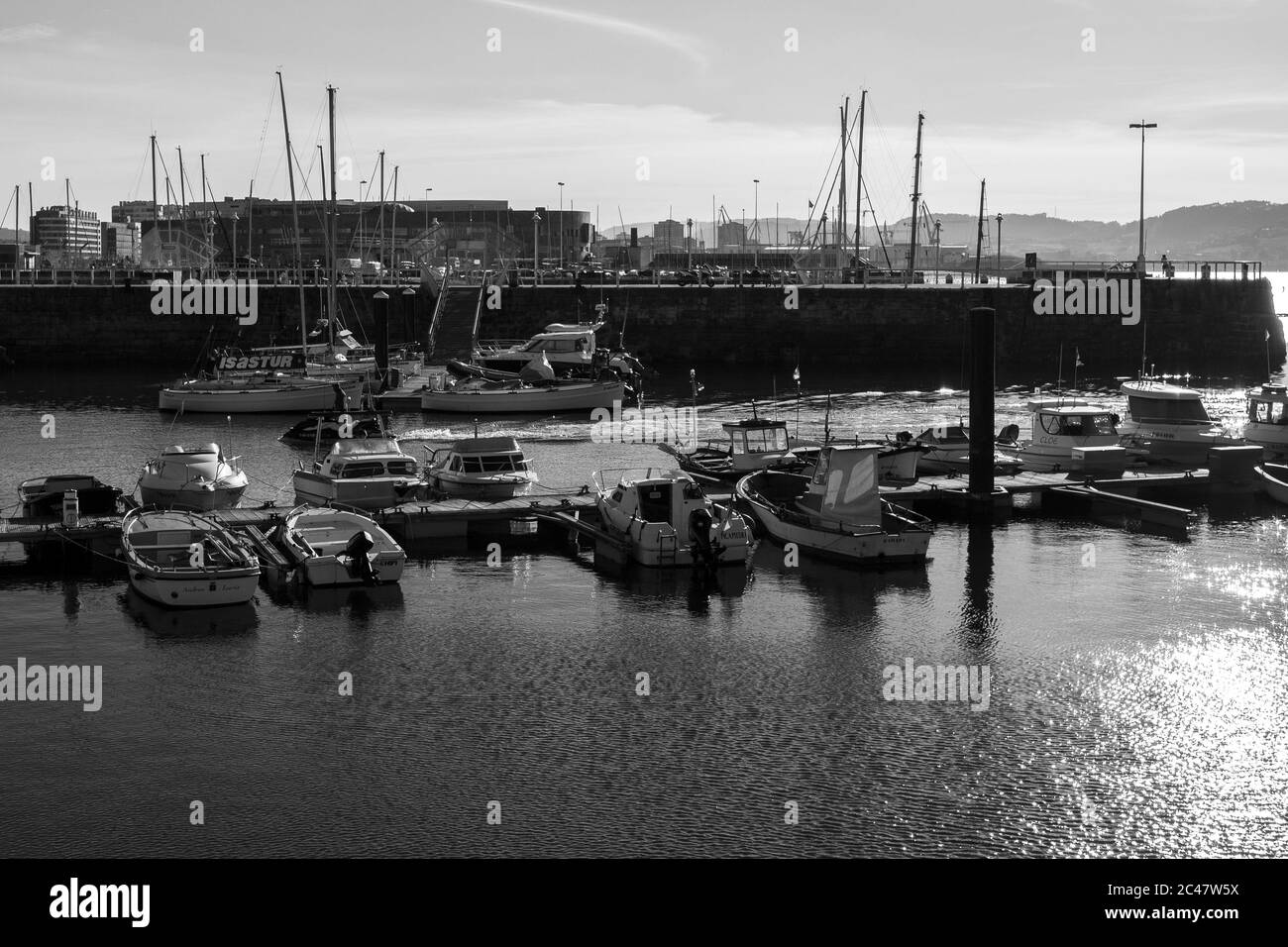 Grayscale shot of the parked small boats near the dock Stock Photo - Alamy