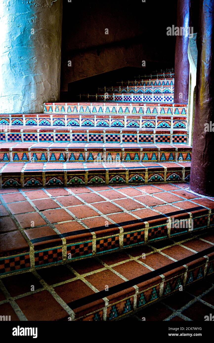 Decorative Spanish tile accents on red brick steps leading up toward the tower at the historic Santa Barbara County Courthouse in Santa Barbara, CA, Stock Photo