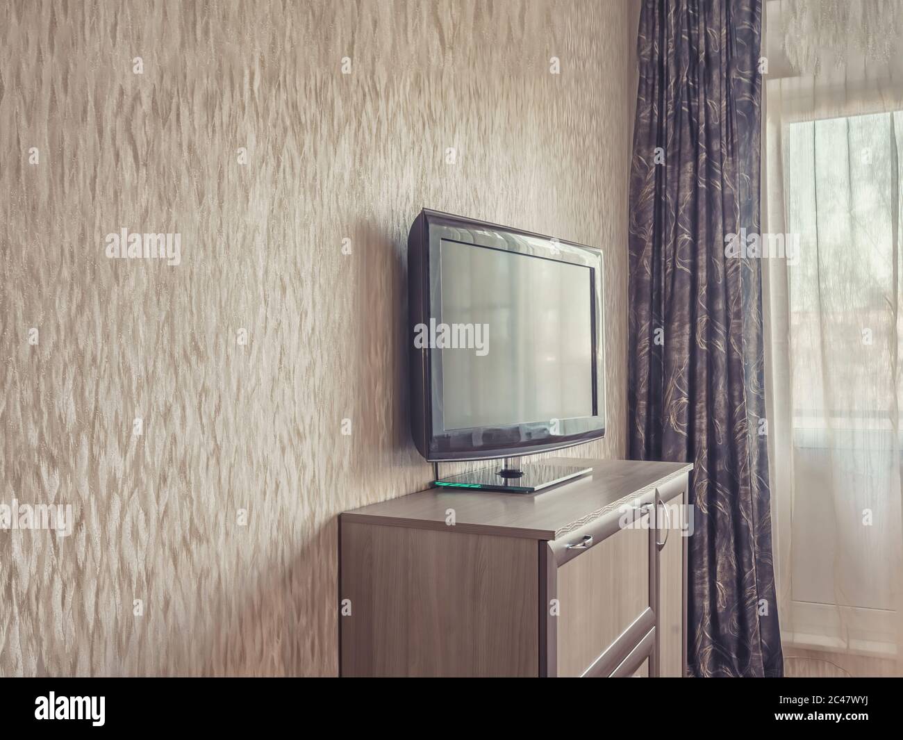 Close up of Flat screen television on shelf near window in room in