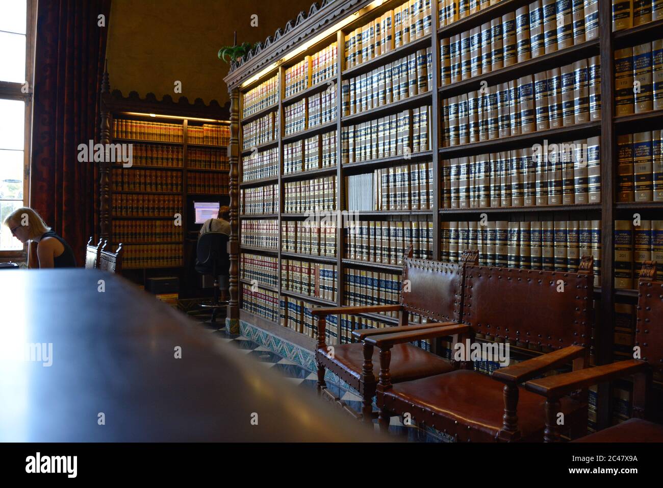 Large reflecting table in the Santa Barbara County Law Library interior with bookcases full of California appellate Report Books and leather chairs Stock Photo
