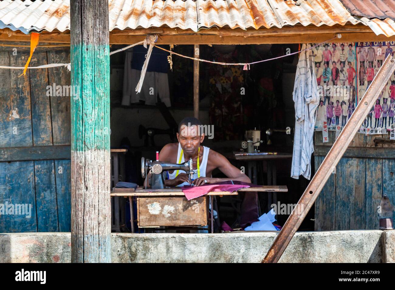 Man at a sewing machine in Sierra Leone Stock Photo
