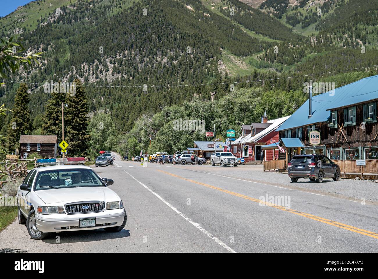 Downtown scene in Twin Lakes, Colorado, with a Deputy CPR Dummy patrolling main street in a parked sheriff's police cruiser Stock Photo