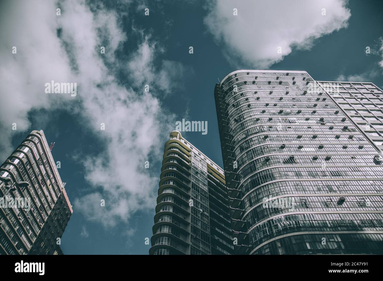 Low angle shot of modern buildings in an urban center against a cloudy ...