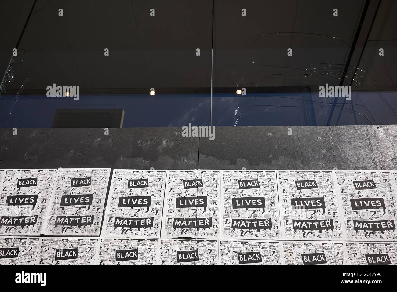 BLM posters on the plywood at the boarded up Apple Store in Pioneer Place in downtown Portland, Oregon. Broken glass wall can be seen from outside. Stock Photo