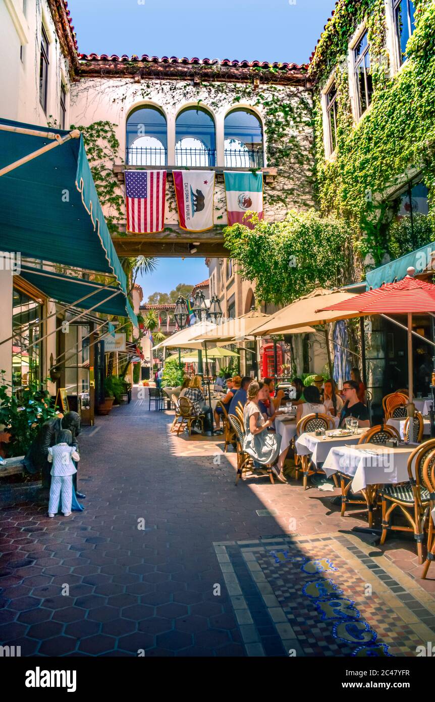 People enjoy outdoor dining on patios of restaurants in the La Arcada Courtyard, an outdoor complex in downtown Santa Barbara, CA, USA Stock Photo