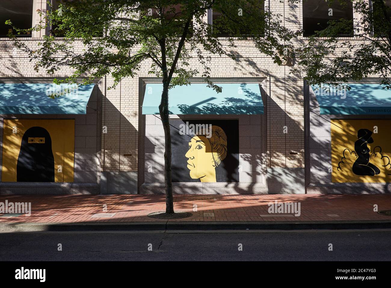 The closed and boarded up Tiffany & Co store in downtown Portland, Oregon, has become unofficial canvases for street artists to make peaceful protests. Stock Photo