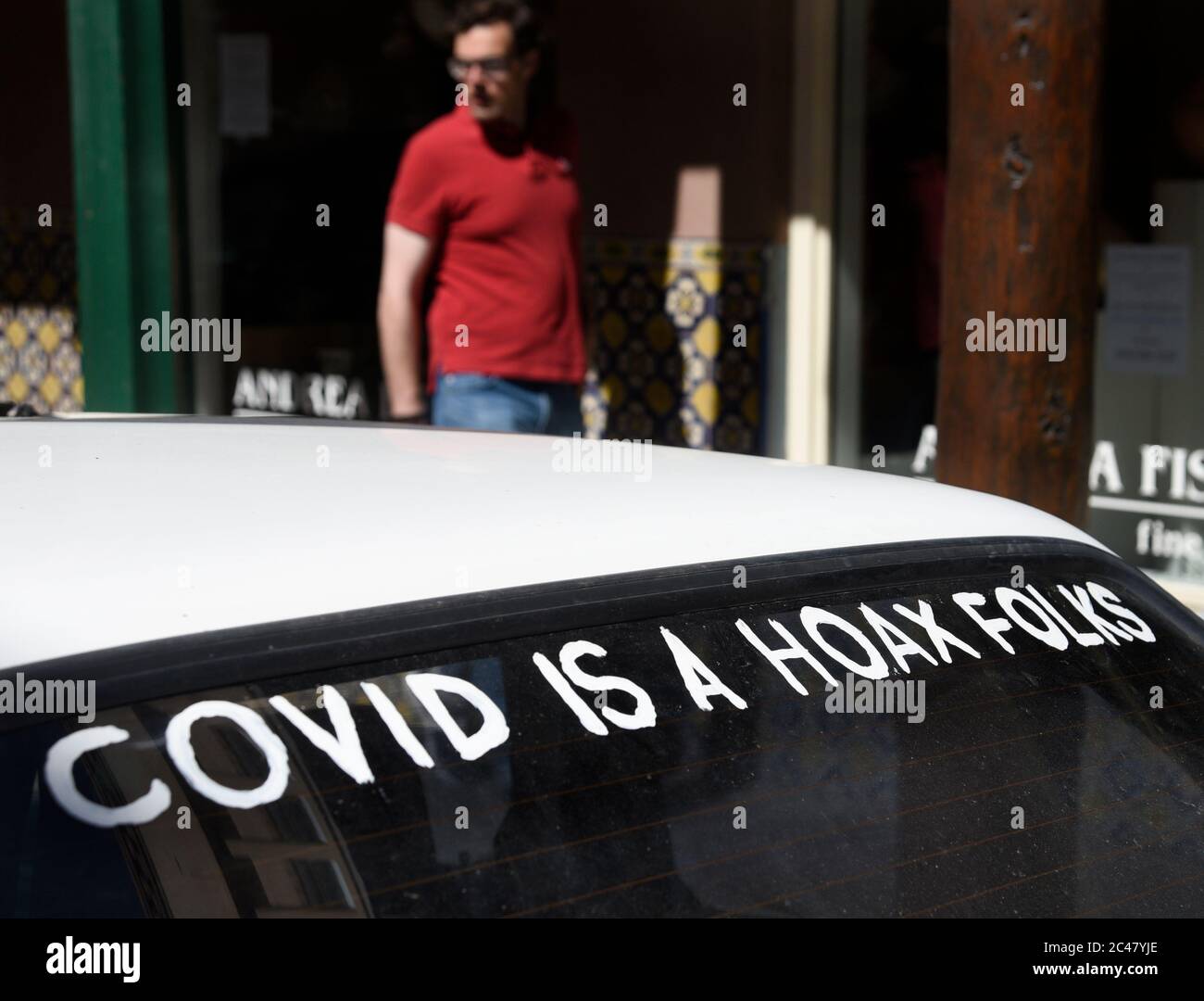 A car with 'Covid is a hoax folks' painted on the rear window in Santa Fe, New Mexico. Stock Photo