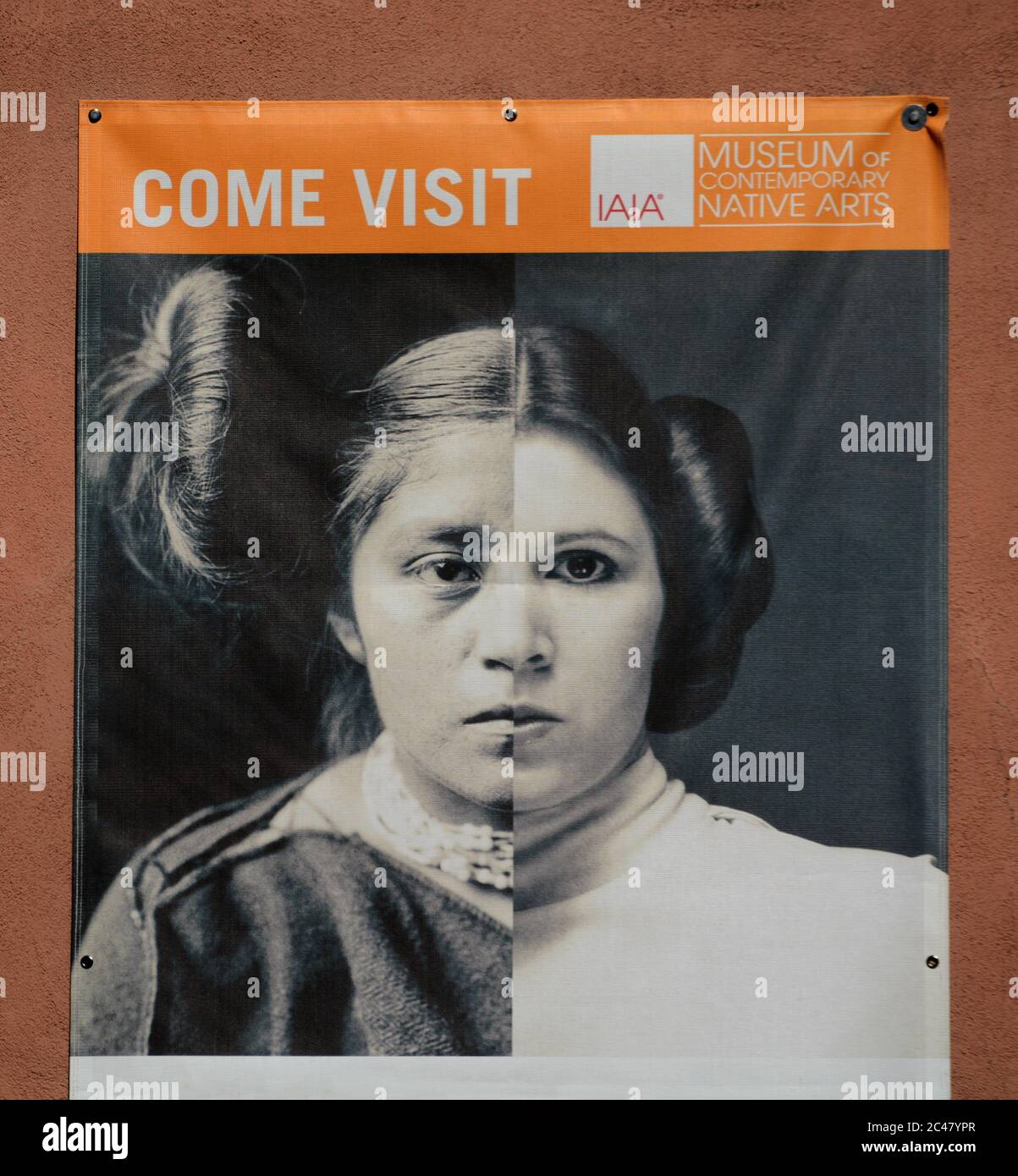 A mural hanging on the front of a Native-American art museum features a creative combination of photos of an historic Hopi girl and Princess Leia. Stock Photo