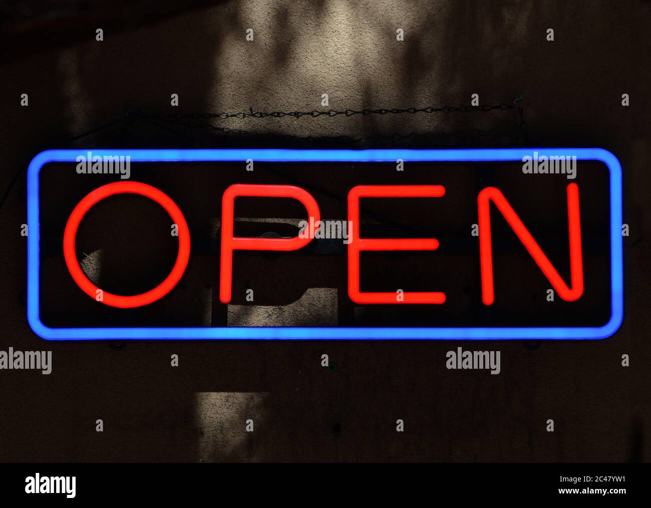 An 'Open' sign hangs in the window of a retail store in Santa Fe, New ...