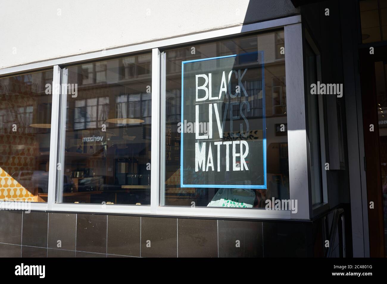 A Black Lives Matter poster is seen at the reopened Public Domain Coffee shop in downtown Portland on Tuesday, 6/23/2020, amid the ongoing BLM protest. Stock Photo