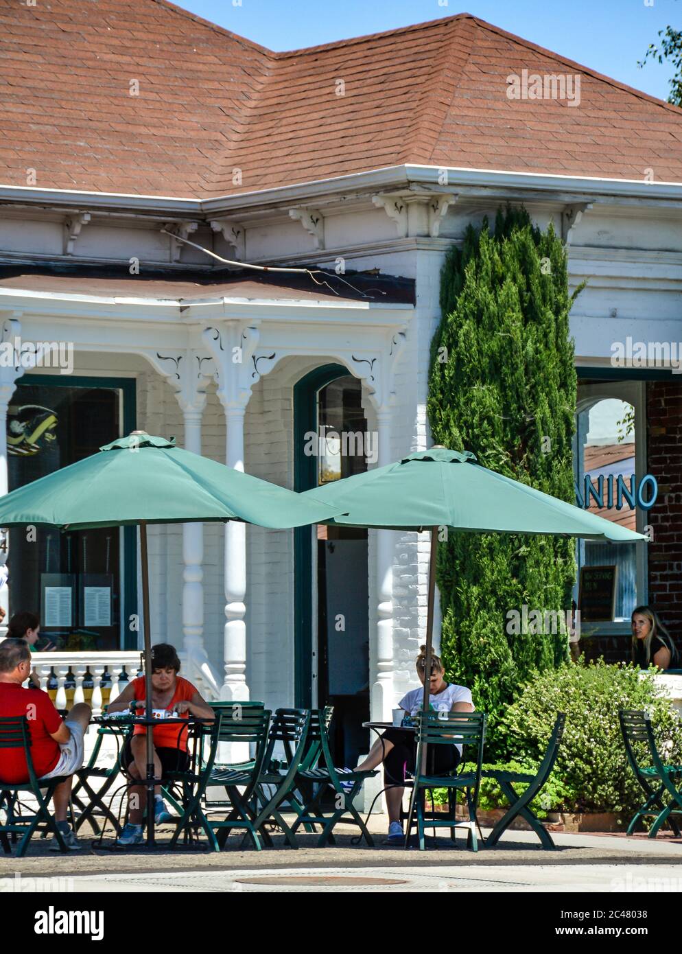 People enjoy sitting outside on the patio at the Panino restaurant in an old Victorian house, downtown Santa Barbra, CA, USA Stock Photo