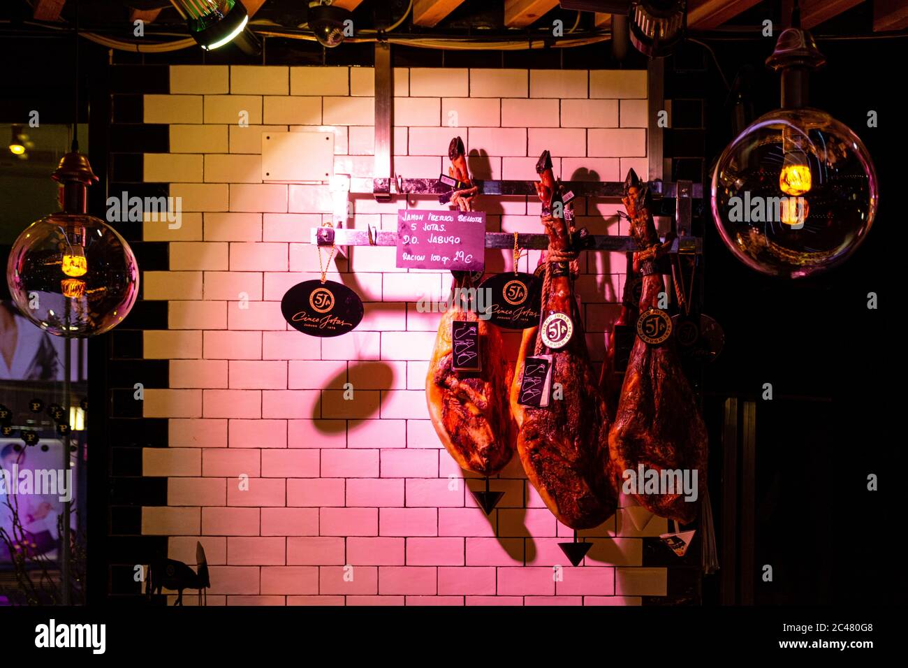 MADRID, SPAIN - Nov 10, 2019: Famos Hamon Iberico hanging in Platea market, Madrid Stock Photo