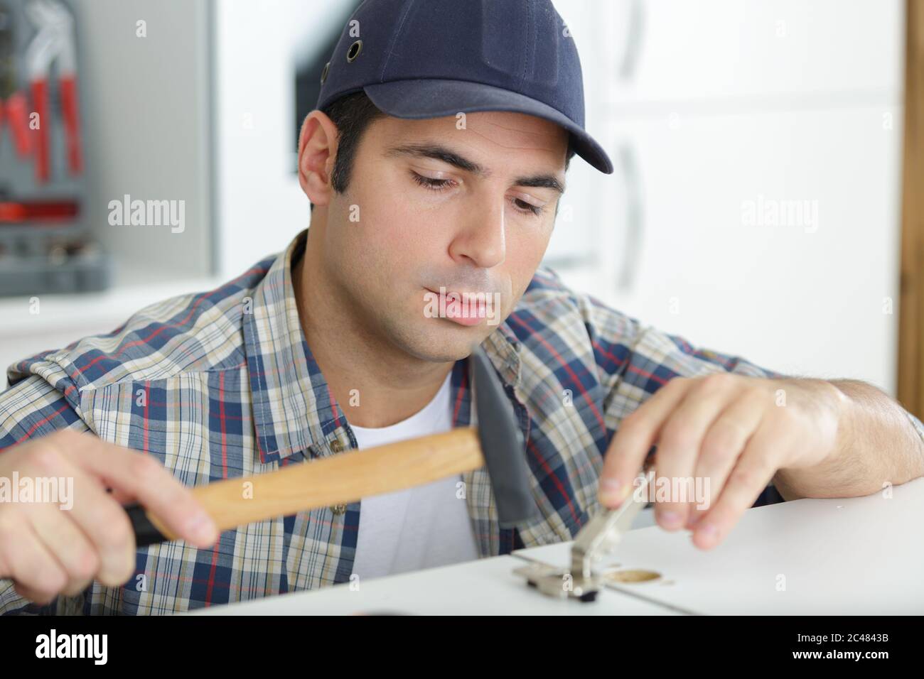 man installing timber laminate flooring with tools Stock Photo Alamy