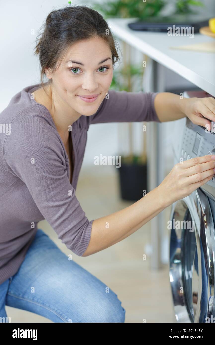 a woman starting washing machine Stock Photo Alamy