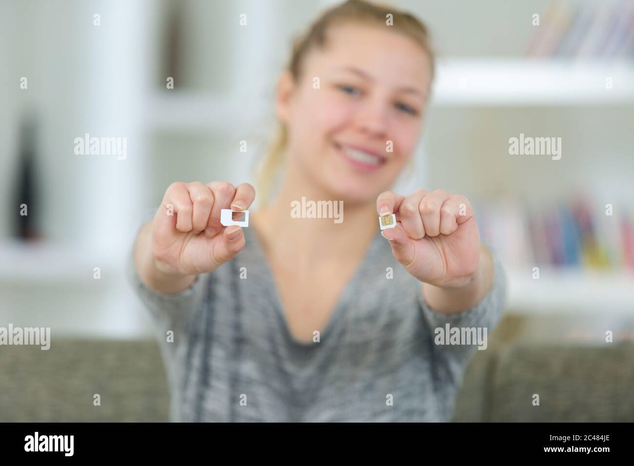 happy woman hand holding a sim card Stock Photo