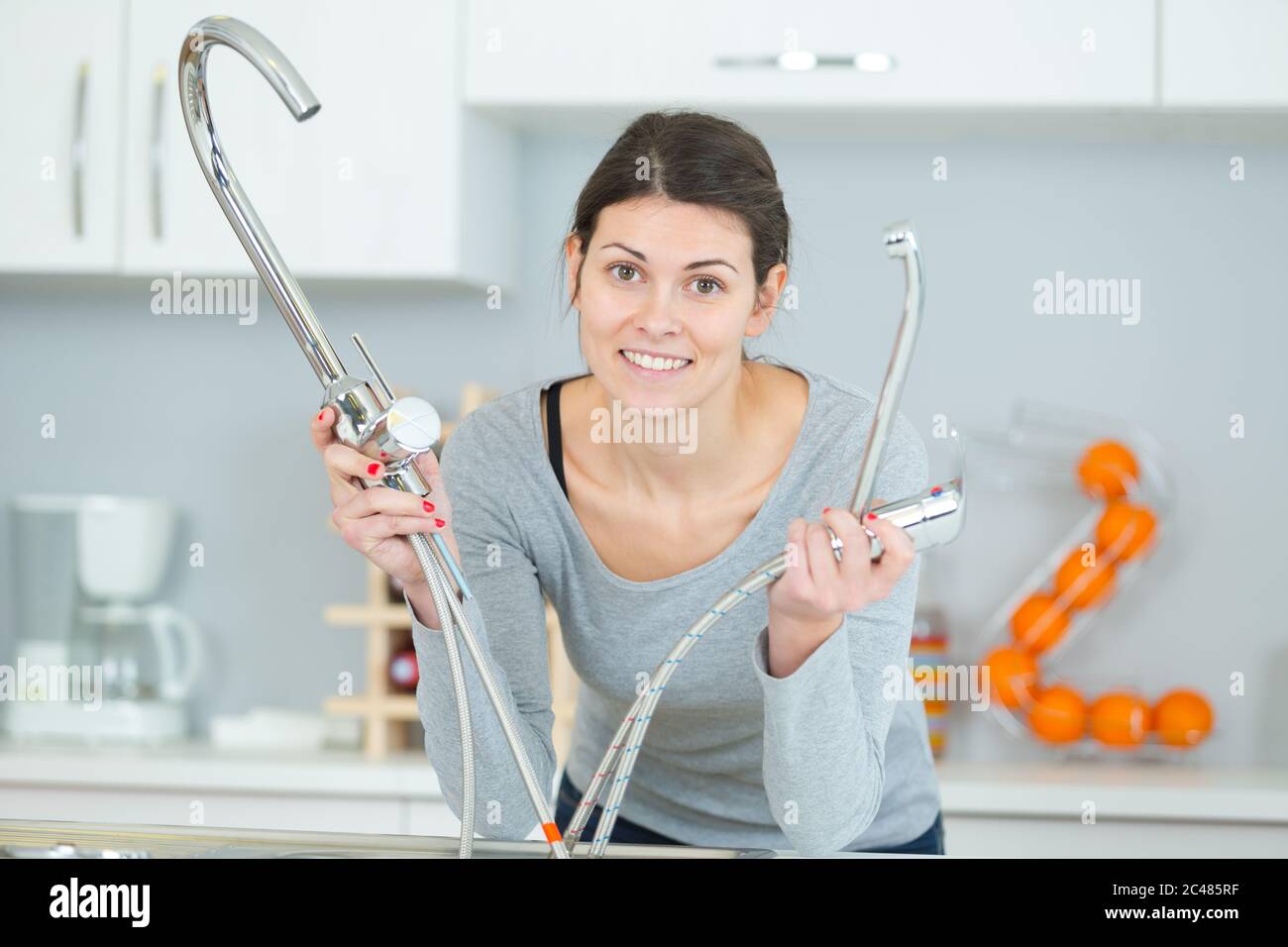 woman removing the old sink tap Stock Photo Alamy