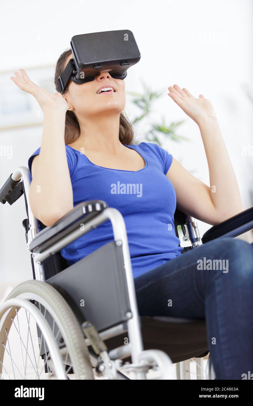 woman in wheelchair using virtual reality glasses Stock Photo - Alamy