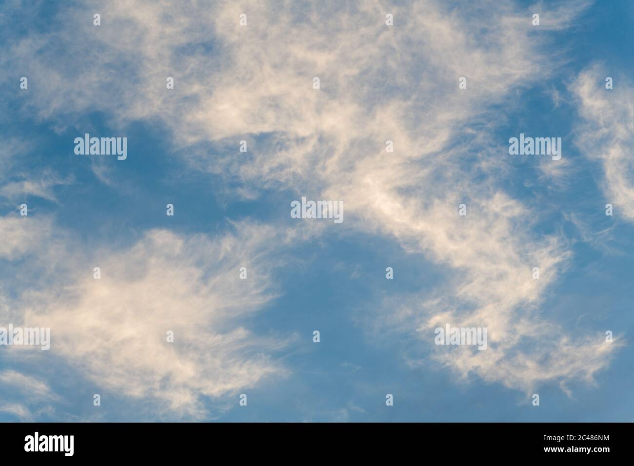 White Wispy Clouds Against a Blue Daytime Sky Stock Photo