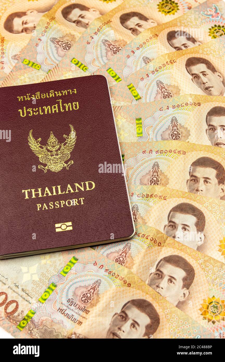 San Sai Noi, San Sai District, Chiang Mai 50210, Thailand - June/23/2020: Picture of a thai passport on 1000 Baht banknotes Stock Photo