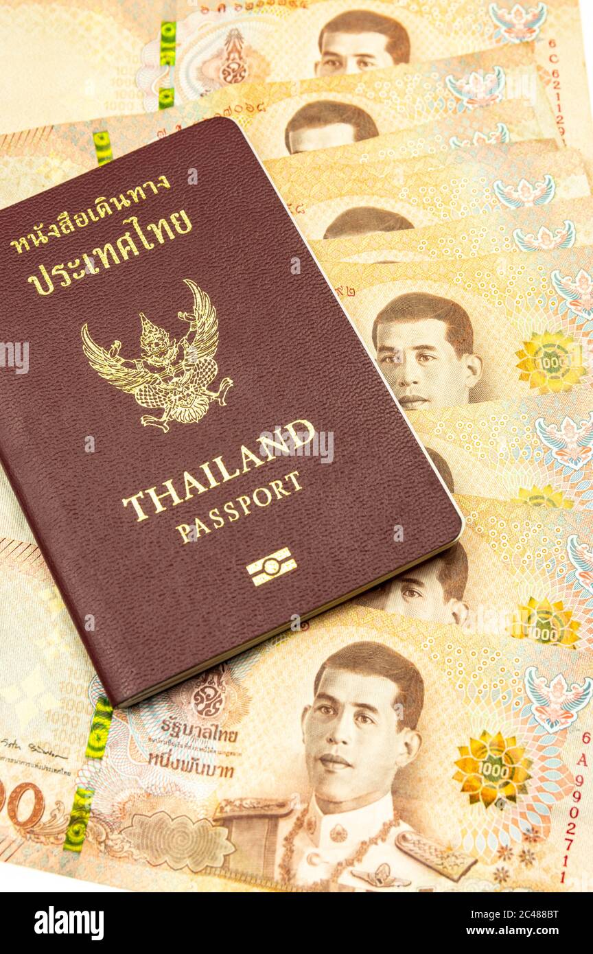 San Sai Noi, San Sai District, Chiang Mai 50210, Thailand - June/23/2020: Picture of a thai passport on 1000 Baht banknotes Stock Photo