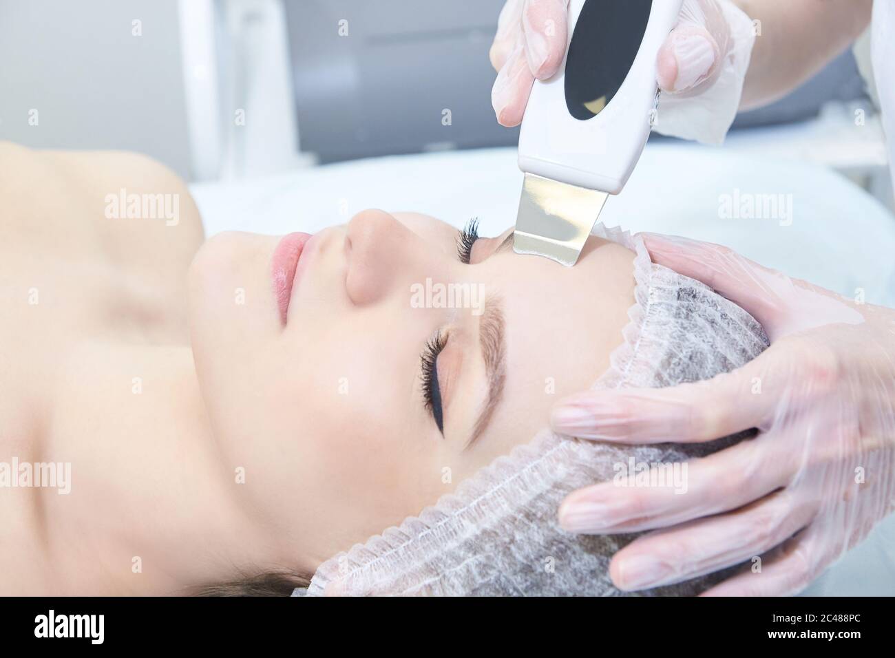 Ultrasonic cleaning of the face. Modern equipment. Cosmetic clinic