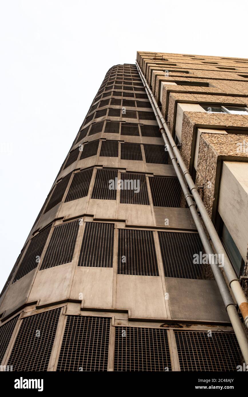 Low angle shot of the exterior of the modern building under a cloudy ...